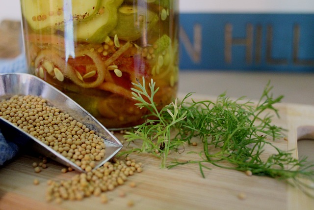 Jar of pickles with yellow mustard seed and spices